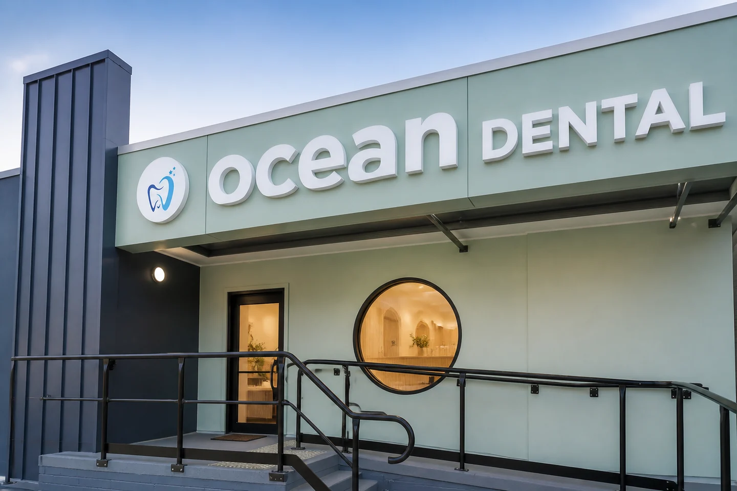Ocean Dental exterior showing seafoam cladding, an accessible ramp and a circular window