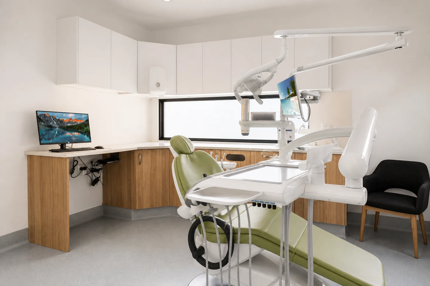 Dental treatment room with a green chair, oak cabinetry and a horizontal window